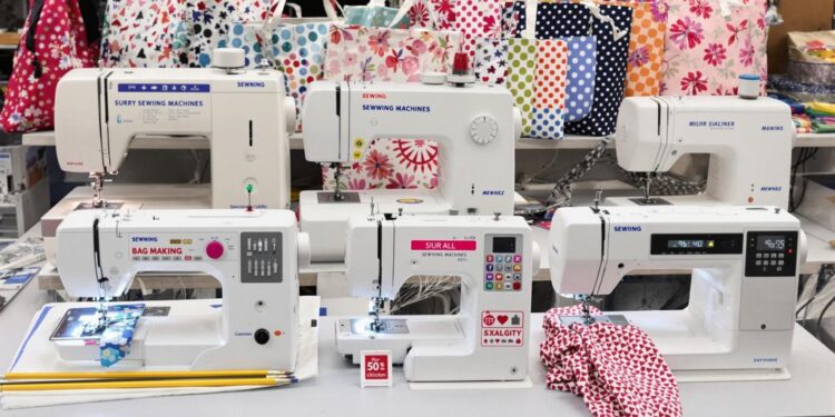 Various sewing machines for bag making on a workbench.
