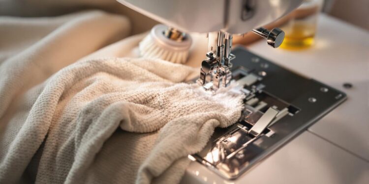 A sewing machine with cleaning tools beside it.