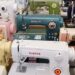Various Singer sewing machines in a colorful arrangement.