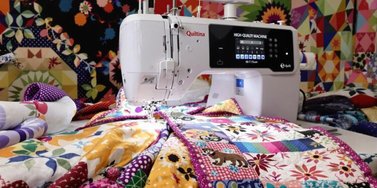 Close-up of a quilting machine with colorful fabrics.