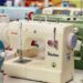 Different models of sewing machines on a table.