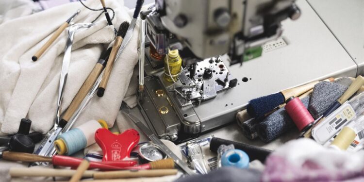 Sewing machine with maintenance tools like oil and brushes.